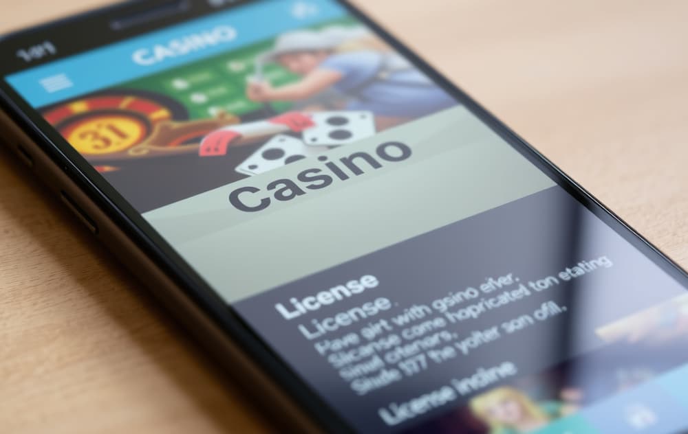 Skjermbilde av casino med lisensinformasjon nederst på mobil.
